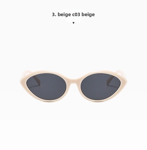 Detailed view of beige cat-eye sunglasses with retro narrow frame and dark lenses