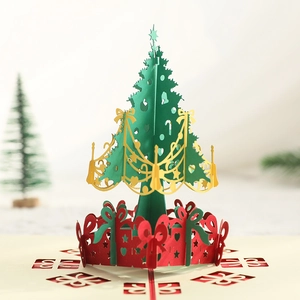 3D pop-up Christmas card featuring an intricate green and gold paper-cut tree design