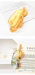 Detail of silk sleep mask set featuring yellow satin and Van Gogh oil painting prints