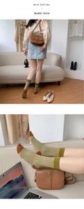 Detailed close-up of yellow and green striped cotton socks with brown toe and heel accents
