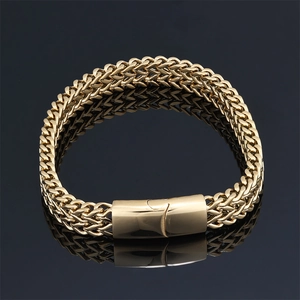 Men's hip hop gold wheat chain bracelet with a polished magnetic clasp on dark mirror
