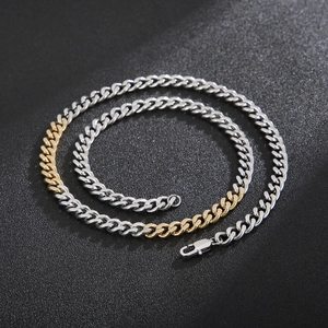 Close-up of dual-tone gold and silver Cuban link chain with a secure lobster clasp