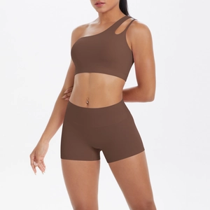 Detail view of chocolate brown one-shoulder sports bra and high-waisted gym shorts set