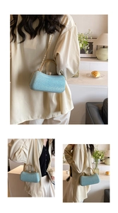 Detail of light blue sequin evening clutch bag with gold metal handle and chain strap