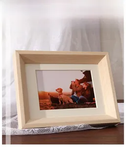 Close-up of light solid wood photo frame with natural grain and white mat on a wooden table