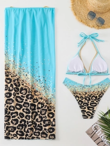 Three-piece leopard print bikini set with chain straps and matching mesh skirt sarong