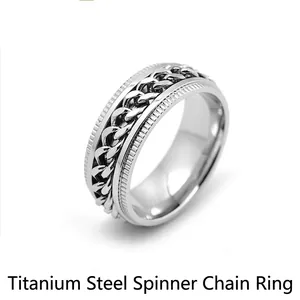Detail of silver titanium steel spinner ring with rotatable cuban chain inlay