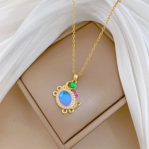 Macro detail of a colorful crab pendant with blue opal and sparkling crystals