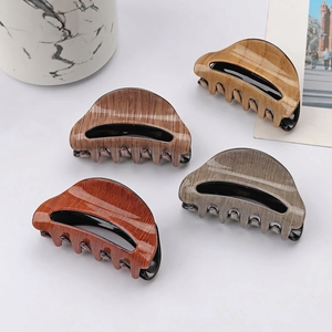 Set of four semi-circle wood grain hair claws in various brown and gray tones