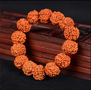 Detailed macro view of natural 5-mukhi rudraksha beads on a carved wooden box