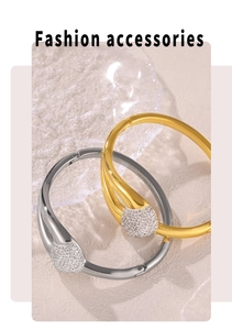 Close-up of sleek gold and silver steel bangles with sparkling zircon inlay detail
