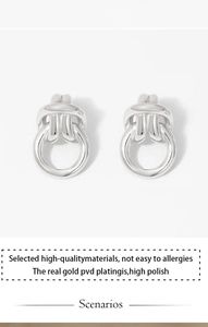 Detail view of double-loop knot earrings featuring PVD coating and high polish finish