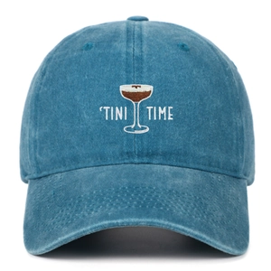 Detailed embroidery of a cocktail glass and 'TINI TIME' on washed blue cotton baseball cap