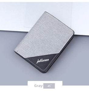 Detail of gray canvas wallet with contrast paneling and white logo on desk