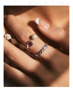 Close-up of S925 silver ring with white pearl and iridescent moonstone in soft light