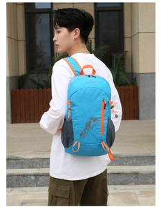 Blue outdoor sports backpack with orange zippers and side mesh pocket shown on model