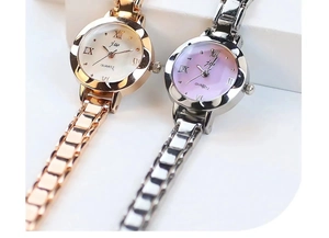 Detailed close-up of quartz watches in rose gold and silver with Roman numeral dials