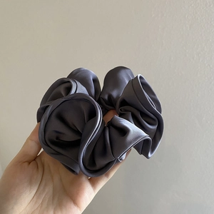 Handheld dark grey satin scrunchie with French vintage ruffles and silky texture