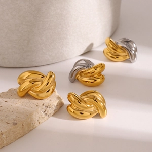 Polished stainless steel twisted knot earrings in gold and silver finish on stones