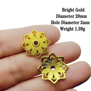 Detail of a 20mm bright gold filigree flower bead cap with 2mm hole for DIY jewelry