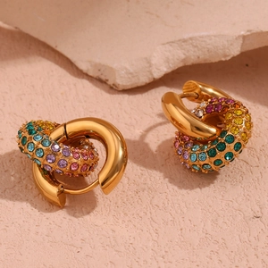 Macro detail of 18k gold plated hoop earrings with colorful inlaid zircon stones