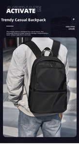 Rear view of a black urban backpack worn by a model in a city street setting