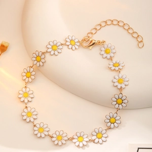 Elegant gold daisy flower bracelet with white and yellow enamel and lobster clasp