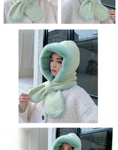 Detail of light green knit balaclava hood with plush faux fur trim and textured finish