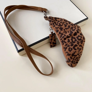 Detail of leopard print crescent coin purse with brown leather strap and silver zipper