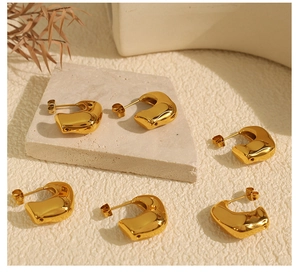 Artistic layout of 18K gold plated stainless steel geometric earrings on stone