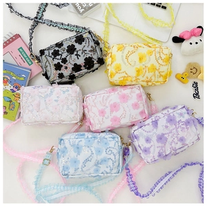 Close-up of six colorful girls' floral bags with 3D lace flowers and sequin details