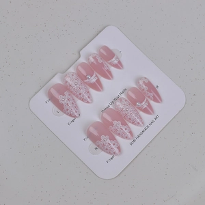Detail of semi-handmade pink jelly press-on nails with white 3D flowers and pearls
