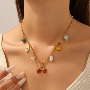 Cute fruit pendant necklace with strawberry and banana charms on a gold bead chain