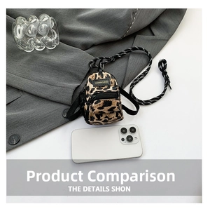 Detailed view of mini leopard print crossbody bag with woven strap and fashion patch
