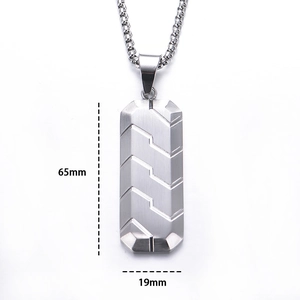 Detailed view of silver hexagonal pendant with tire tread pattern and size dimensions