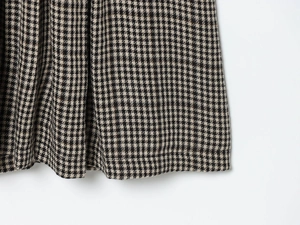Detailed close-up showing the premium black and white houndstooth fabric texture and weave