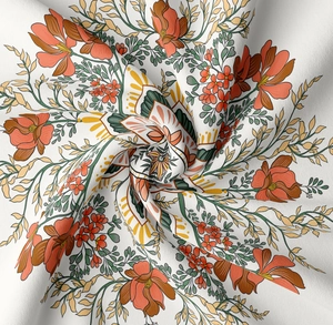 Detailed macro view of vintage mandala floral fabric with vibrant orange and green prints