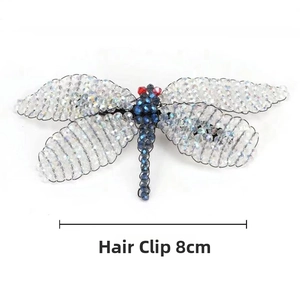 Detailed view of an 8cm handmade beaded dragonfly hair clip with crystal accents