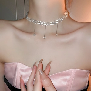 Sparkling clear glass bead choker necklace with three pendants on a model's neck