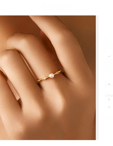 Detail of s925 silver ring with white pearl and micro diamonds on model hand