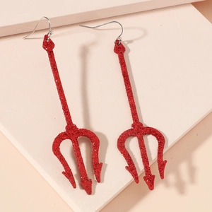 Close-up of red glitter devil trident earrings on a soft pink minimalist background