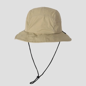 Close-up of beige quick-dry hiking hat with adjustable black chin strap and toggle