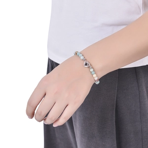 Detail of heart projection stone bracelet with colorful natural beads on a model's wrist