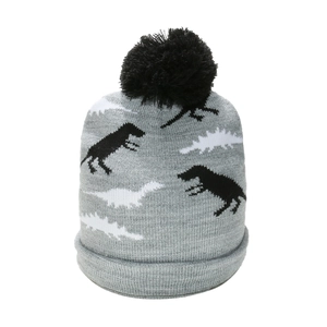Detailed macro view of the grey knit texture and black dinosaur pattern on children's winter hat