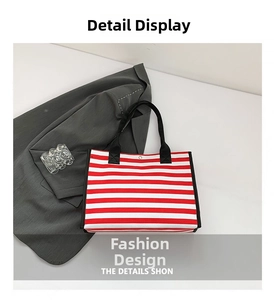 Detail showing red and white striped canvas tote bag with black webbing straps