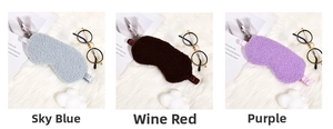 Close-up of soft sherpa fleece sleep masks in blue, burgundy and purple with elastic straps