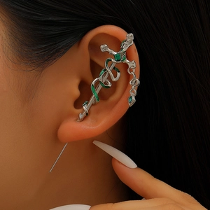Detail of silver sword earring with green snake wrap and zircon stone on ear