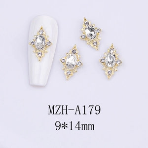 Macro detail of luxury diamond nail charms with gold alloy base and rhodium crystals