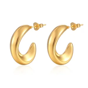 Detail of chunky gold-plated C-shape stainless steel earrings with butterfly backings