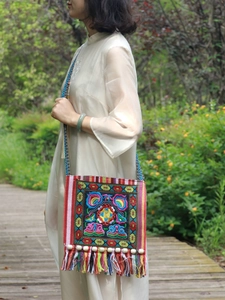 Ethnic embroidery crossbody bag with colorful tassels and traditional floral geometric patterns